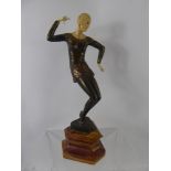 An Art Deco Dancer, raised on a rose marble plinth, approx 35 cms, unsigned.