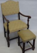 An Oak Framed Elbow Chair, together with a footstool. (2)