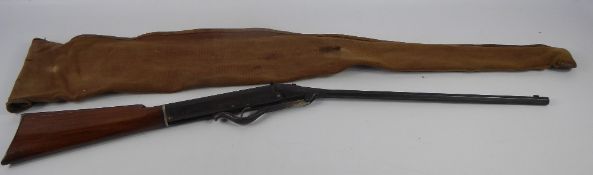 An Antique Air Rifle, the air rifle having octagonal barrel and mahogany stock, with original canvas