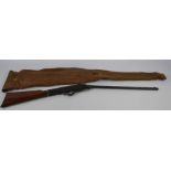 An Antique Air Rifle, the air rifle having octagonal barrel and mahogany stock, with original canvas