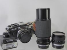 An Olympus Camera, together with wide angle lens, Super Ozeck II 300m lens, Olympus flash, fitted