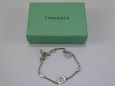 Three Solid Silver Bracelets, together with a heart shaped pendant and chain, with a Tiffany &