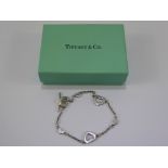 Three Solid Silver Bracelets, together with a heart shaped pendant and chain, with a Tiffany &