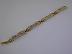 A Lady's Swarovski Crystal Cocktail Bracelet, together with a Swarovski topaz coloured fancy ring,