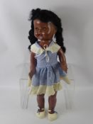 A Vintage Walking Doll, sleeping eyes and articulated limbs, smiling mouth revealing top teeth,