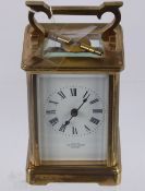 A 8 Day Brass Carriage Clock, white enamel face with Roman dial, stamped Mappin & Webb, London, with