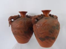 A Pair of Antique Chinese Terracotta Dragon Twin Handled Vases, the vases having handles in the form