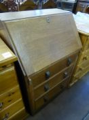A Light Oak Mid 20th Century Drop Front Bureau, with three graduated drawers and fitted interior,