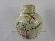 A Ginger Jar, decorated with flowers, butterflies and birds, approx 21 cms high, with lid.