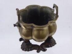 An Antique Japanese Bronze Censer, the melon form bowl with leaf decoration, raised on tapered