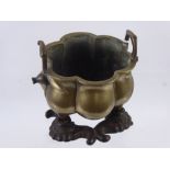 An Antique Japanese Bronze Censer, the melon form bowl with leaf decoration, raised on tapered