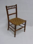 An Antique Pine Child's Chair, with rush seating.