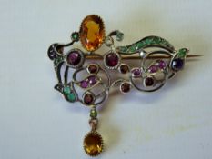 An Antique Silver and Gold, Ruby, Emerald, Garnet and Amethyst Brooch.