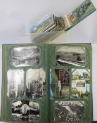 A Blue Album of Vintage Postcards, including black and white photo cards and a quantity of world