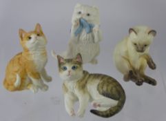 Four Royal Worcester Feline Figurines, including Siamese, Ginger, Tabby and a Persian. (4)