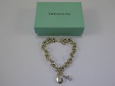 A Tiffany & Co., Solid Silver Bracelet with Heart Shape and Charms, approx 28 gms.