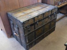 An Ebonised Sea Captain's Trunk, with wooden stays, iron studs and fittings, leather strap