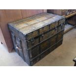 An Ebonised Sea Captain's Trunk, with wooden stays, iron studs and fittings, leather strap