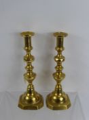 A Pair of Antique Georgian Brass Candle Sticks, approx 25 cms high.