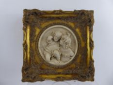 A Circular Marble Plaque, carved in relief, depicting affectionate children, within a gilt wood