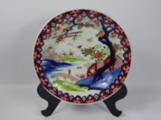 A 19th Century Japanese Imari Charger and Vase, the charger depicting a lone figure in a landscape