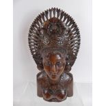 A Hand Carved Feminine Bust, in the Indonesian style, approx 40 cms.