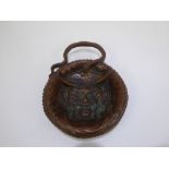An Antique Copper Dish, embossed with a mandarin figure to the base.