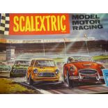 A Vintage Scalextric Motor Racing Track, with three vintage cars, transformer, hand controllers