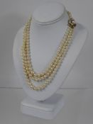 A Lady's Three Strand Graduated Pearl Necklace, with 9 ct yellow and white gold and diamond clasp.