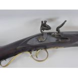 An Antique Flintlock Musket, the musket having a polished brass trigger guard, butt plate, ramrod