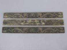 A Pair of Chinese Silver Scroll Weights, character marks 990 silver, depicting chasing dragons