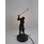 A Contemporary Composite Lamp Base, depicting a golfer in full swing, horizontal opaque glass