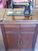A Vintage Singer Sewing Machine, cabinet mounted.