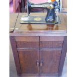 A Vintage Singer Sewing Machine, cabinet mounted.