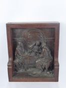 A Cast Bronze Plaque in relief, depicting a Biblical scene 'The Supper at Emmaus', mounted in an oak
