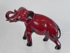 A Royal Doulton 'Flambe' Elephant Figurine, with trunk raised, printed mark to underside, approx