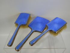 A Silver and Blue Enamel Dressing Table Set, comprising mirror and two hairbrushes, mm Mappin &