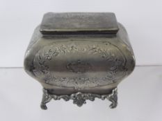 A 19th Century Pewter Tea Caddy, embossed with floral design, dated 1862.