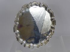 A Solid Silver Salver, the salver having a scalloped edge on scroll feet, Sheffield hallmark dated