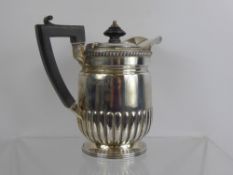 A Carrington & Co Silver Hot Water Pot, London hallmark, mm John Bodman, ribbed body with ebony