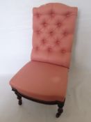 A Victorian Rosewood Framed Button Back Chair, on turned legs, upholstered in pink.