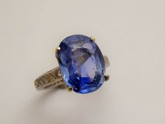 A 6.49 Carat Ceylon Non-Heat Treated Cornflower Blue Sapphire and Diamond Ring; the soft blue oval