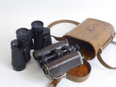 A Pair of Trieder Army Issue Binoculars. in the original case, together with a pair of Boots field