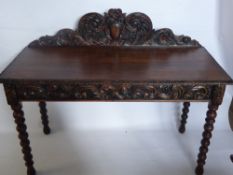 An Antique Carved Oak Sideboard, the sideboard features a carved frieze to back depicting heart