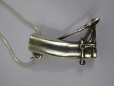 A Silver Riding Boot Pendant, silver hallmarks, on a fine chain together a pair of amber stud