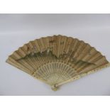 A 19th Century Chinese Paper and Ivory Fan, hand painted with figures in a garden feeding birds,