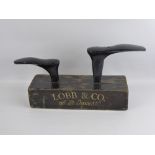 A Lobb of London Advertising Twin Shoe Anvil, black with gold lettering.
