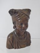 An African Carved Bust of a Lady, with glass eyes, approx 15 cms h.