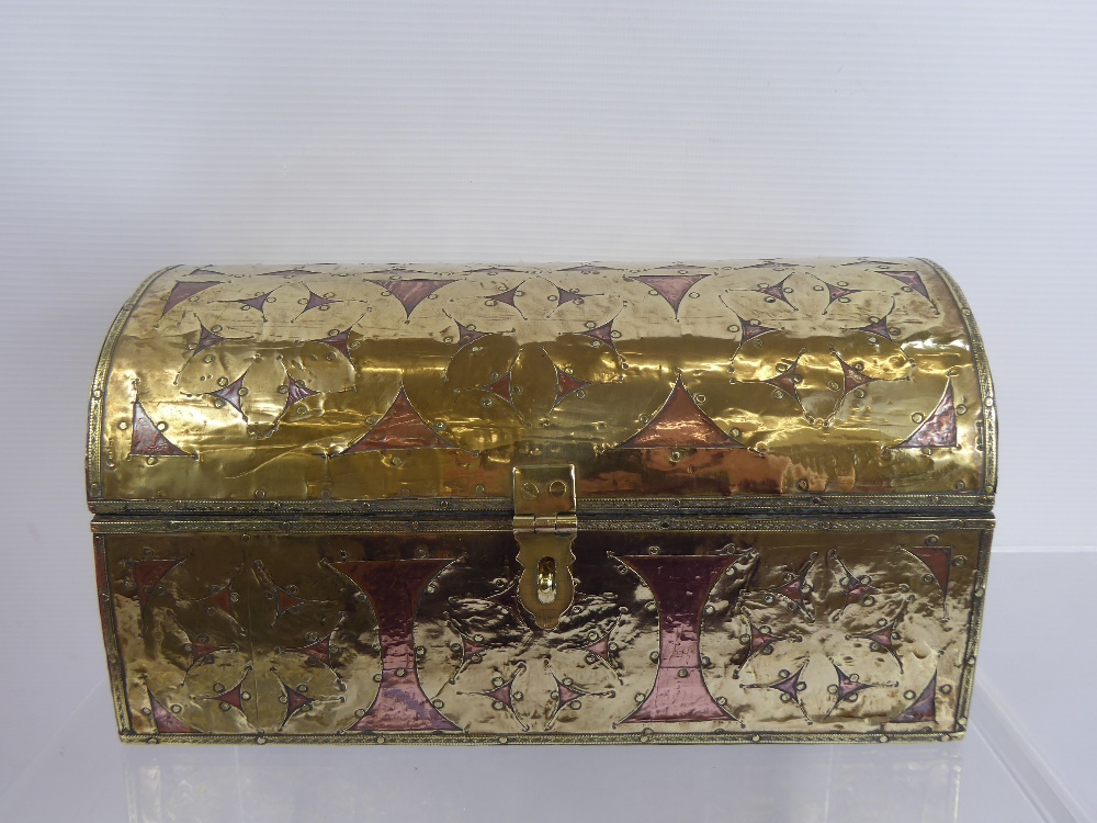 A Brass and Copper Domed Casket, the casket depicting floral spandrels, approx 26 x 15 x 13 cms.