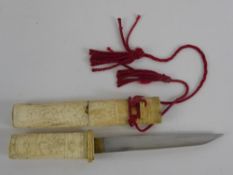An Antique Japanese Tanto with hand carved bone koshirae, the blade measures approx 17.5 cms,